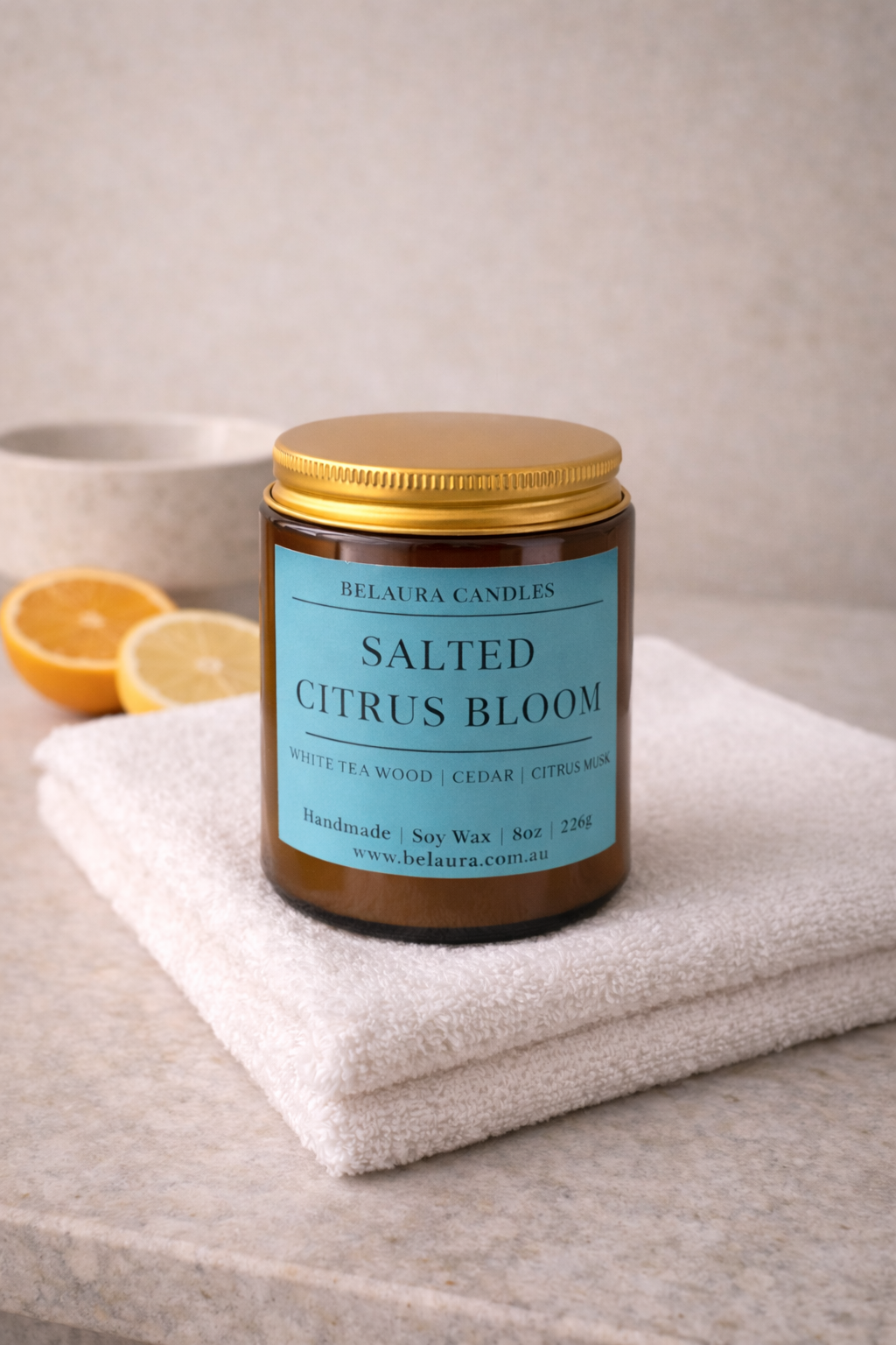 Close-up of Salted Citrus Bloom candle label on amber jar